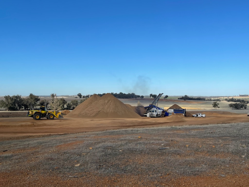SuperCivil wheel loader, material stockpiles and screening plant on a rural Western Australian earthworks site
