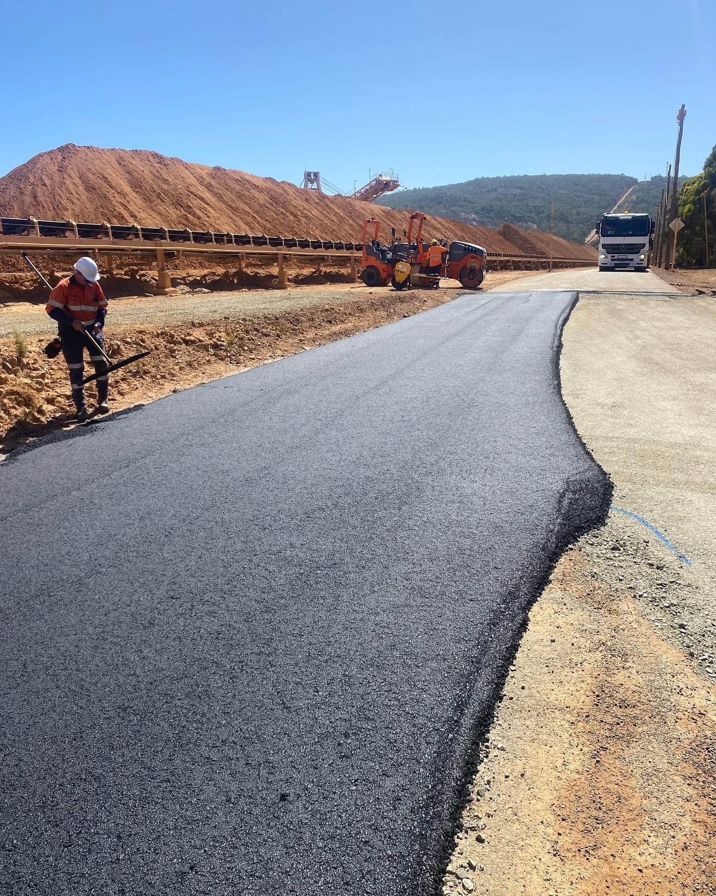SuperCivil crew sealing a mine access road with rollers and stockpiles at a Western Australian resources site