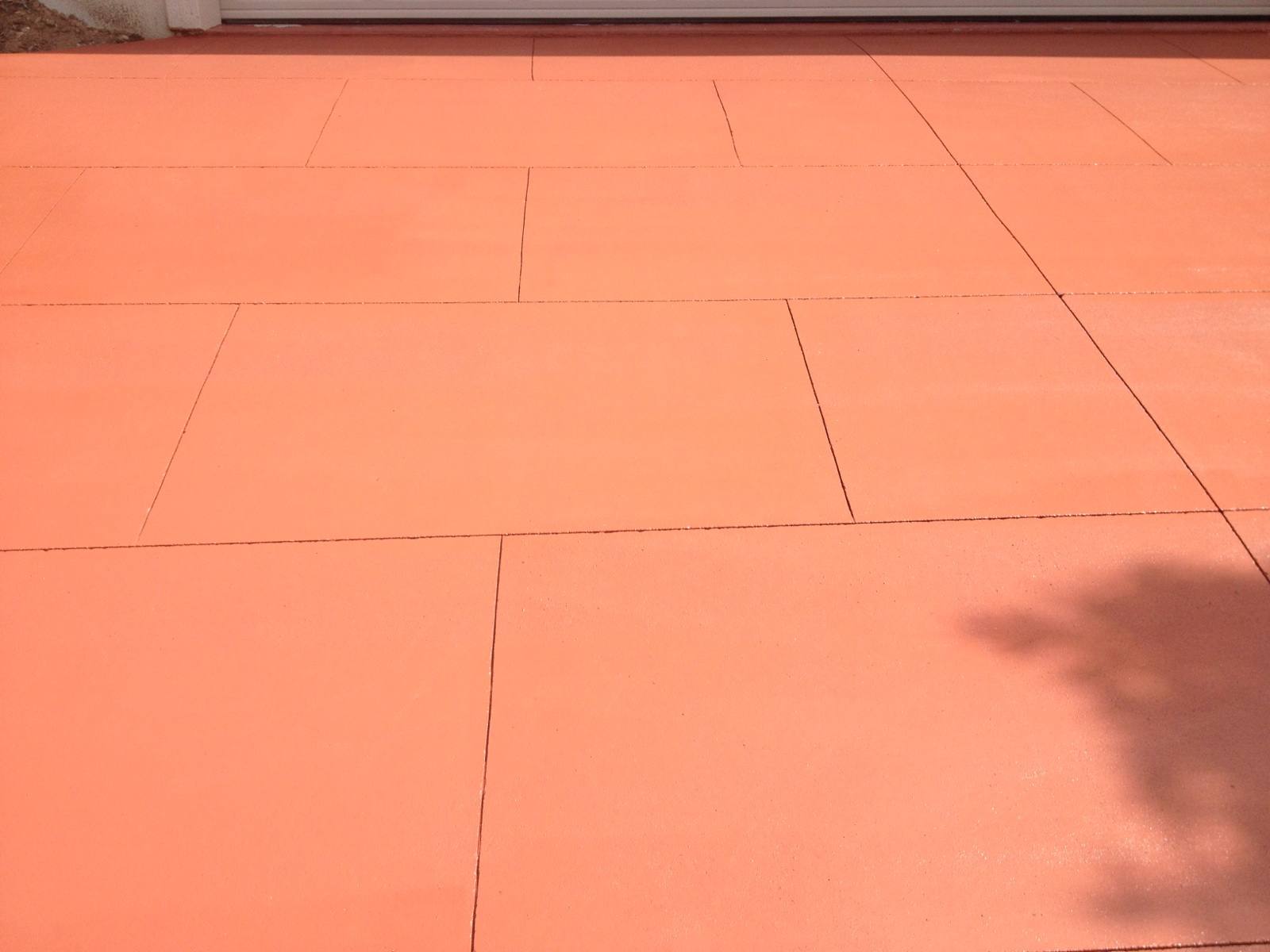 Finished terracotta coloured concrete surface with a sawn-joint tile pattern on a Western Australian patio
