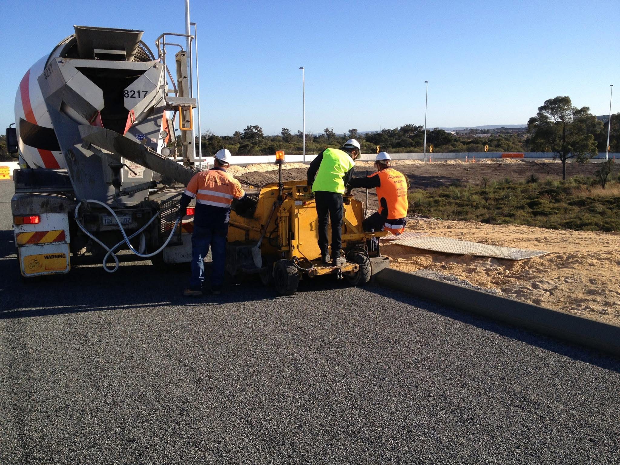 SuperCivil crew laying extruded concrete kerb with a kerbing machine on a Perth road project